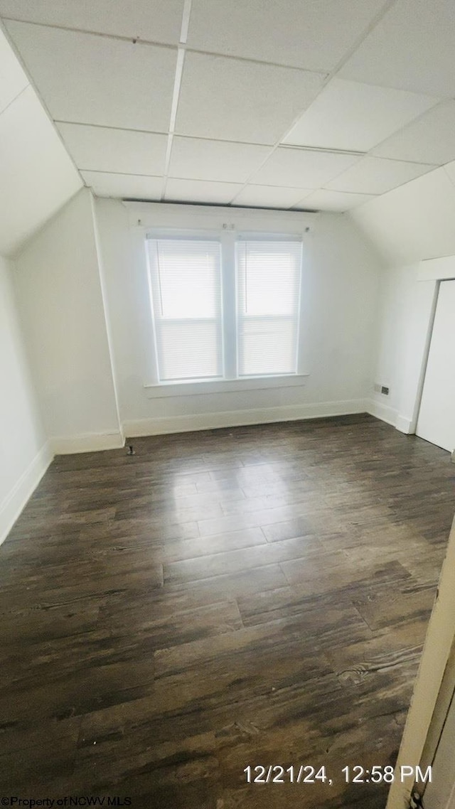 bonus room with vaulted ceiling and dark hardwood / wood-style floors