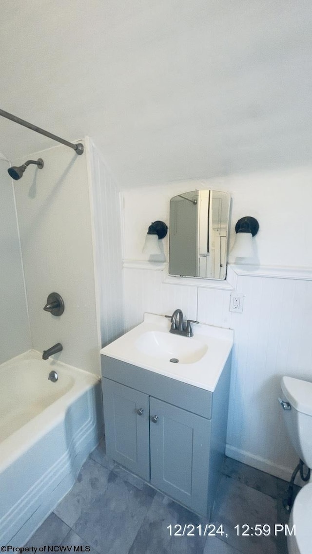 full bathroom featuring vanity, bathing tub / shower combination, and toilet