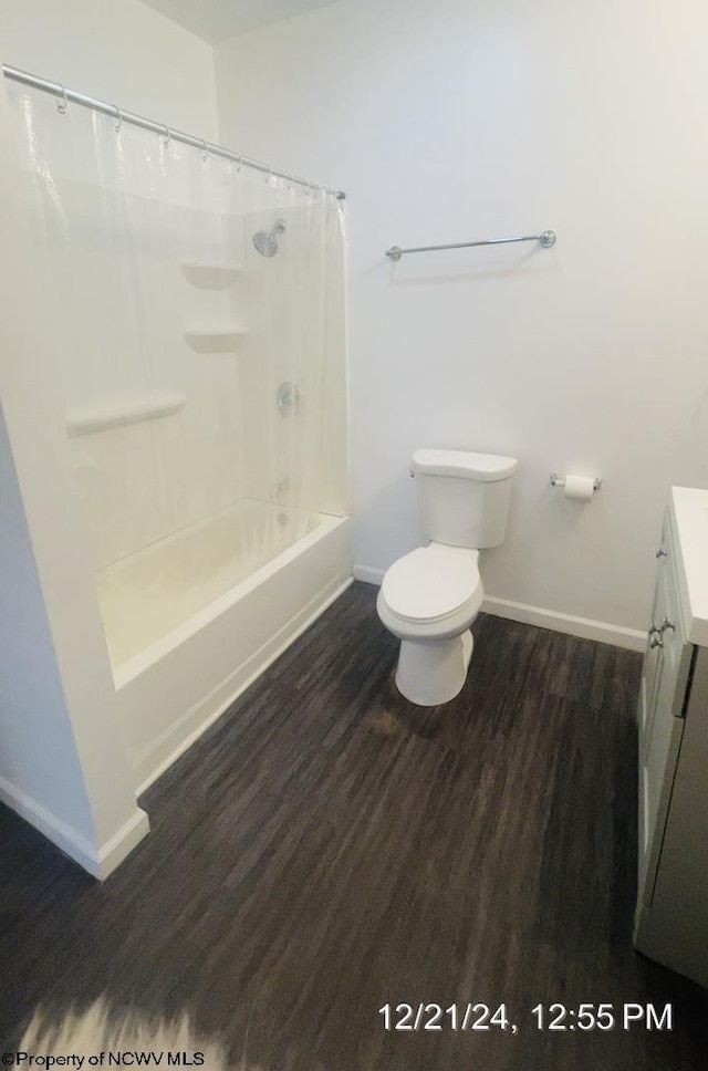 full bathroom with hardwood / wood-style flooring, vanity, toilet, and shower / bath combo with shower curtain