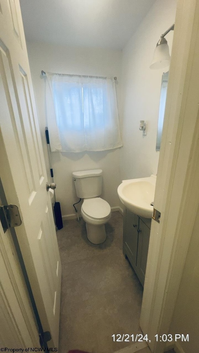 bathroom featuring vanity and toilet