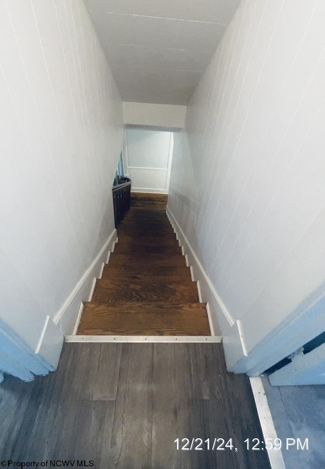 stairs with hardwood / wood-style flooring