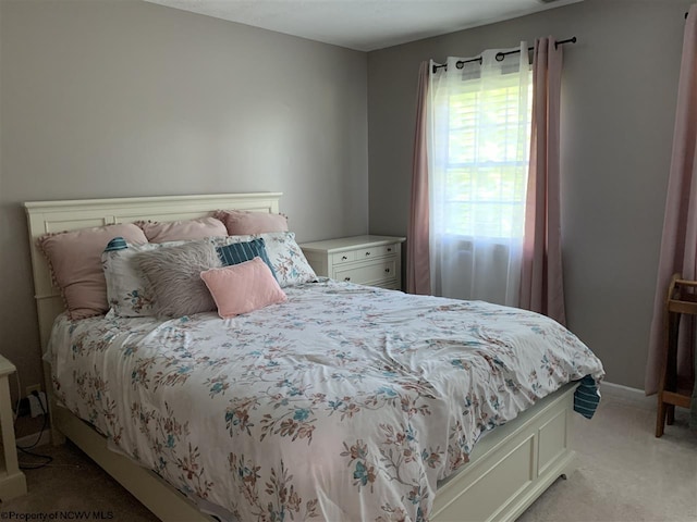 carpeted bedroom featuring multiple windows