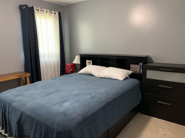 bedroom featuring light colored carpet