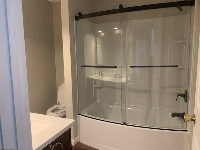 full bathroom with vanity, shower / bath combination with glass door, and toilet