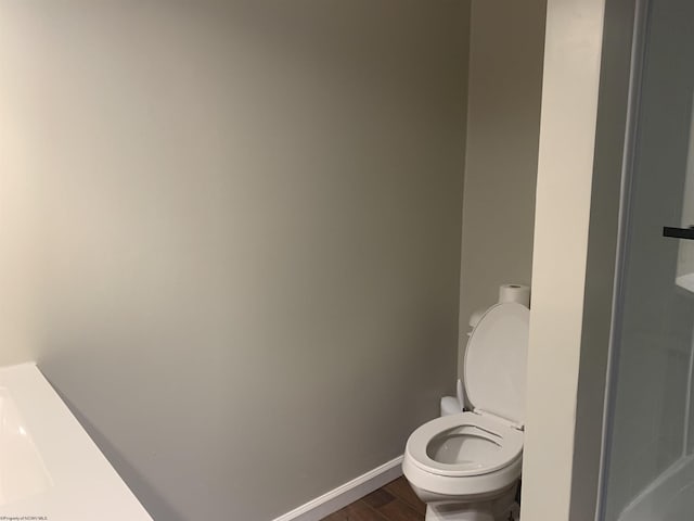 bathroom featuring toilet and hardwood / wood-style floors