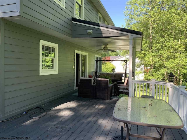 wooden deck featuring an outdoor living space and ceiling fan