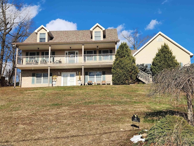 rear view of house featuring a lawn