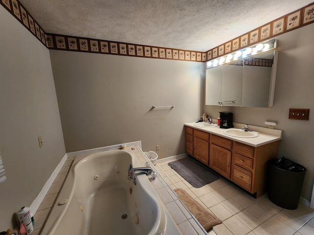 bathroom featuring tile patterned flooring, vanity, a tub, and a textured ceiling