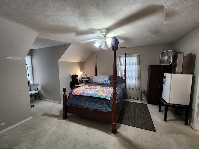 carpeted bedroom featuring ceiling fan, vaulted ceiling, and a textured ceiling