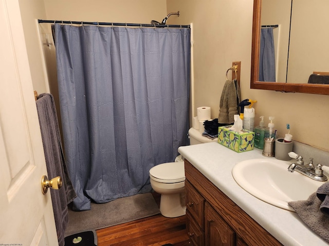 bathroom featuring vanity, hardwood / wood-style floors, and toilet