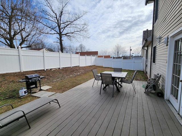 wooden terrace featuring a grill