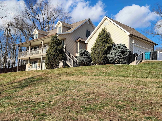 view of home's exterior with a garage, a yard, and a balcony