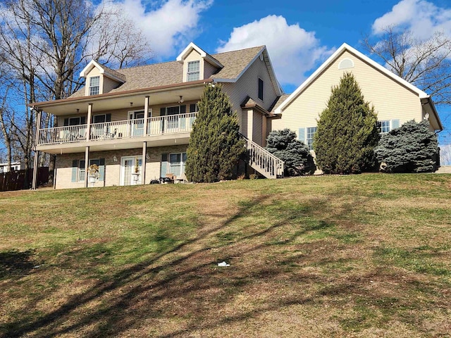 rear view of house featuring a yard