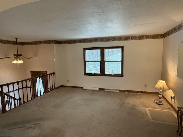 unfurnished room featuring carpet floors and a textured ceiling