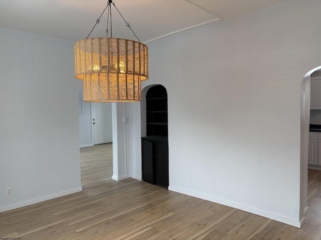 unfurnished dining area featuring light wood-type flooring