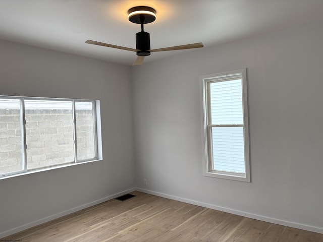 spare room featuring ceiling fan and light hardwood / wood-style floors