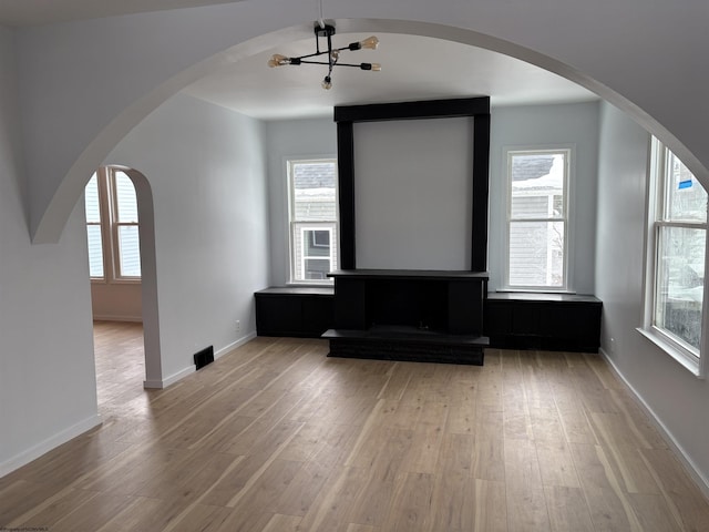 bonus room with light hardwood / wood-style flooring and a healthy amount of sunlight