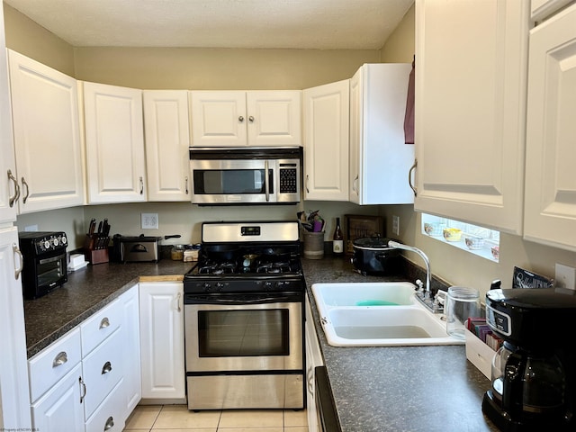 kitchen featuring sink, stainless steel appliances, and white cabinets