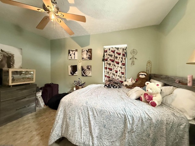 carpeted bedroom with a textured ceiling and ceiling fan