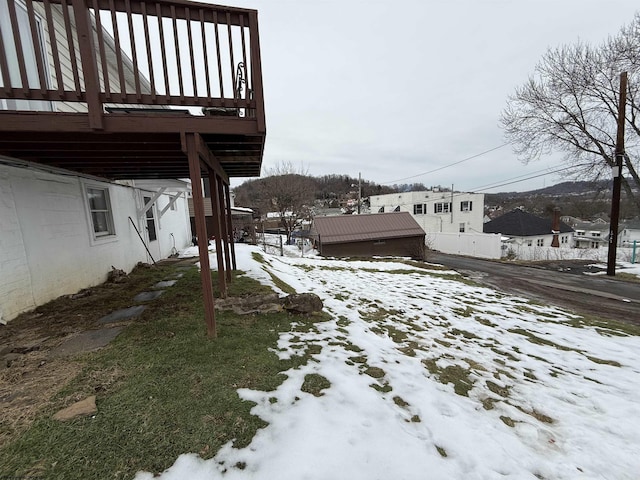 yard covered in snow featuring a wooden deck