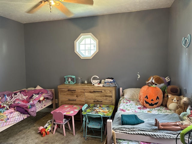 carpeted bedroom featuring ceiling fan and a textured ceiling