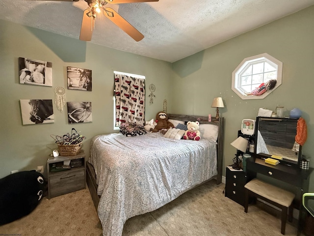 carpeted bedroom with ceiling fan and a textured ceiling