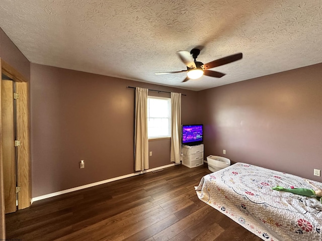 unfurnished bedroom with dark wood-type flooring, ceiling fan, and a textured ceiling