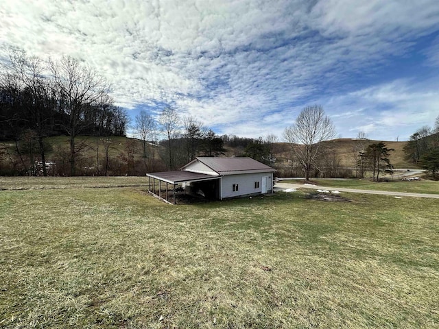 view of yard with a carport and a rural view