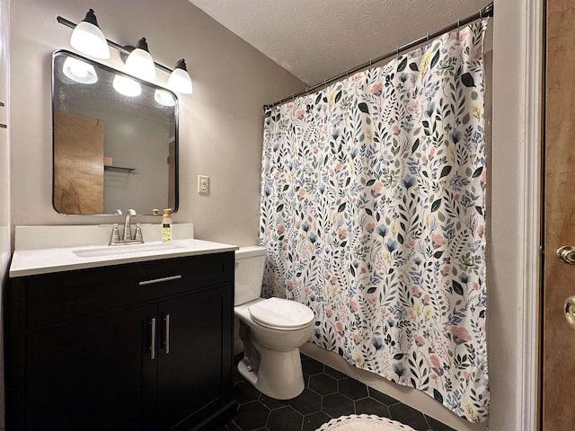 bathroom featuring vanity, a textured ceiling, tile patterned floors, toilet, and walk in shower