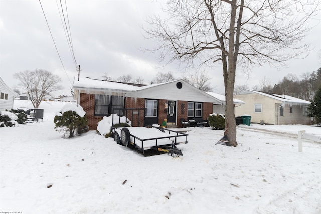 view of snow covered rear of property