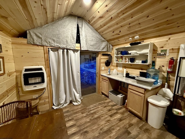 interior space featuring wood ceiling, hardwood / wood-style floors, heating unit, and wood walls