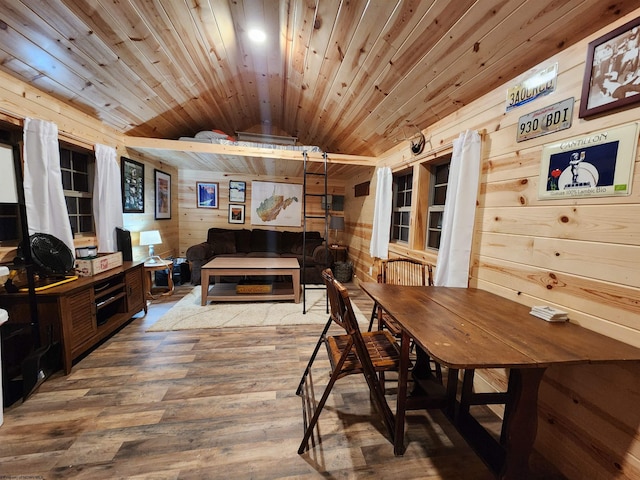 dining room with lofted ceiling, hardwood / wood-style floors, wood ceiling, and wood walls