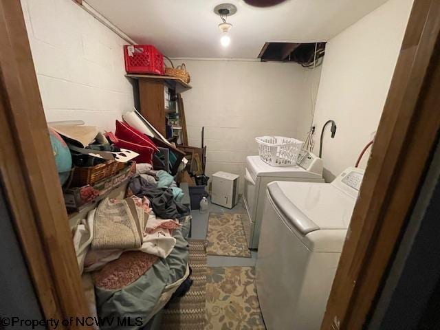 clothes washing area with washer and clothes dryer