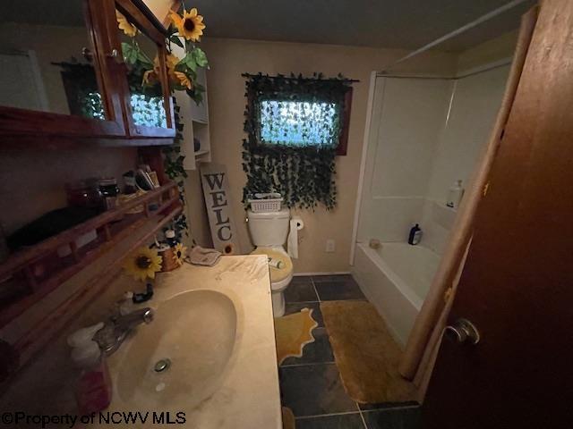 full bathroom with sink, toilet, tile patterned flooring, and shower / bathing tub combination