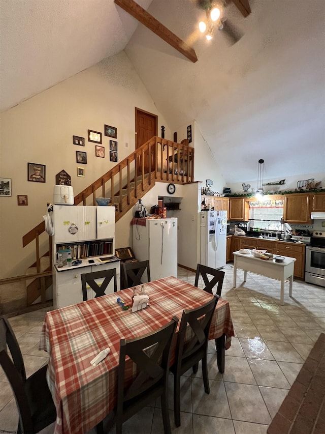 dining area featuring high vaulted ceiling, light tile patterned floors, and ceiling fan