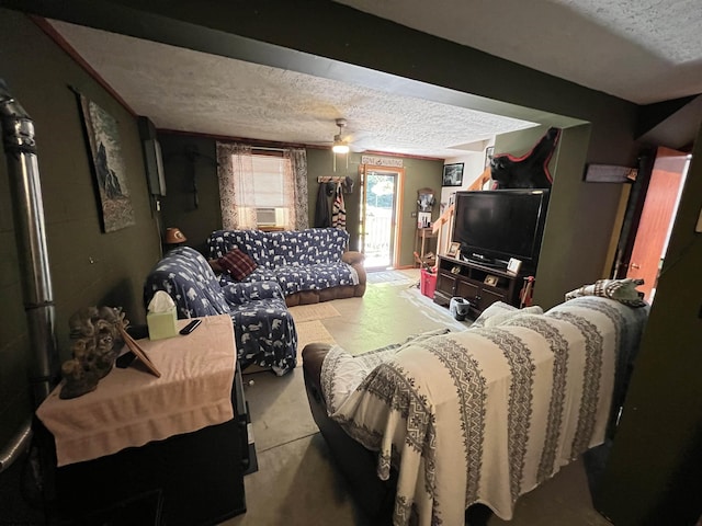 living room with ceiling fan and a textured ceiling