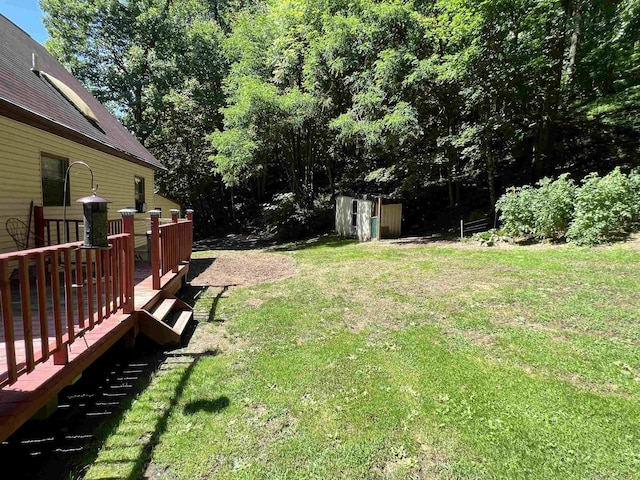 view of yard with a wooden deck and a shed