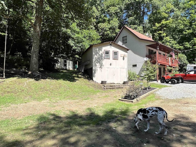 exterior space featuring a wooden deck and a lawn