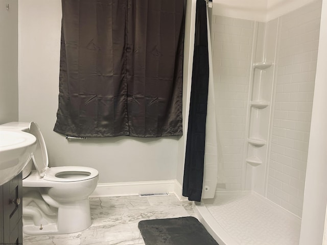 bathroom featuring toilet and walk in shower