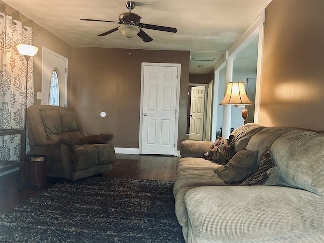 living room featuring ceiling fan and dark hardwood / wood-style flooring