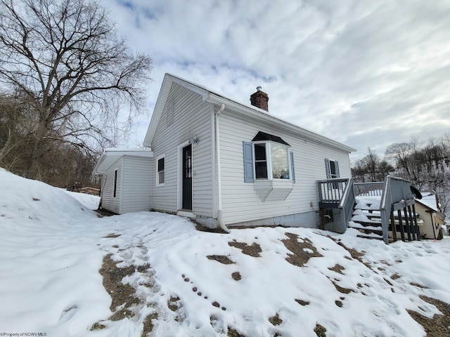 snow covered property featuring a wooden deck