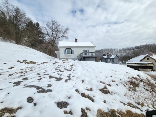 yard layered in snow featuring a wooden deck