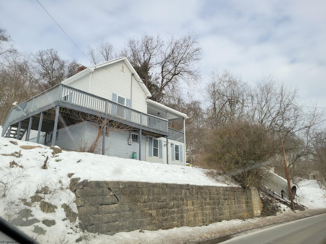 view of snow covered exterior featuring a deck