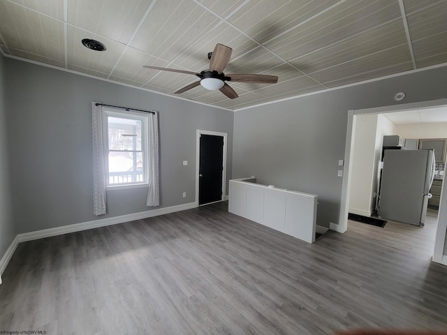 spare room with crown molding, light hardwood / wood-style flooring, and ceiling fan