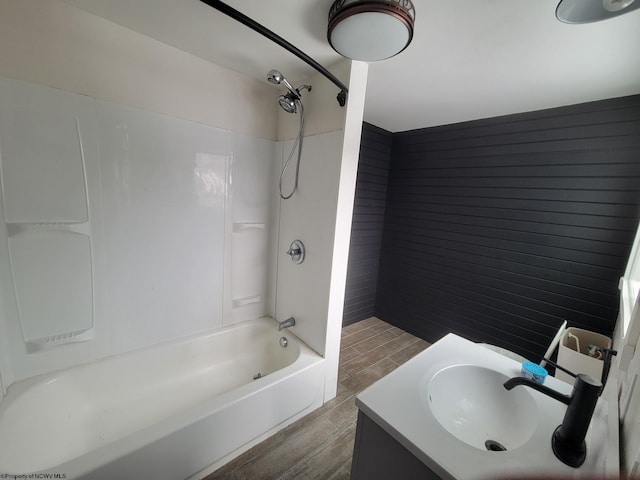 bathroom with sink, hardwood / wood-style floors, and bathtub / shower combination