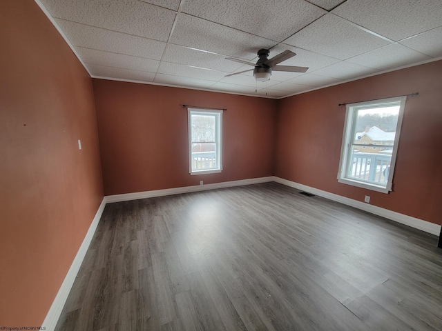 unfurnished room featuring wood-type flooring, ceiling fan, and a paneled ceiling