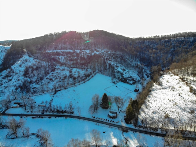 snowy aerial view featuring a mountain view