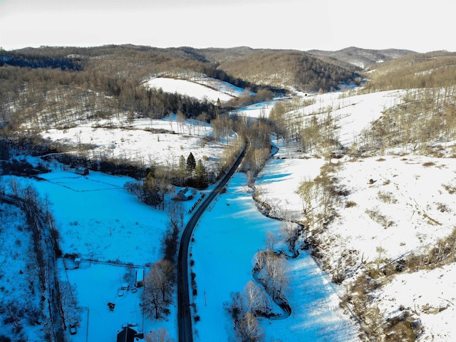 snowy aerial view featuring a mountain view