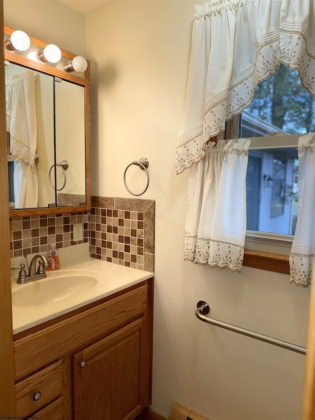 bathroom featuring vanity and backsplash