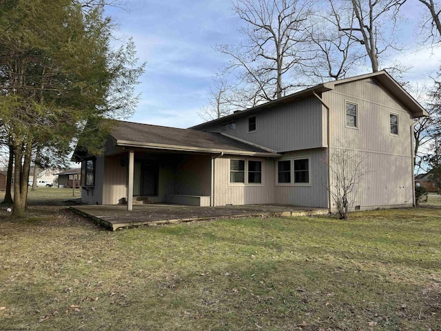 back of property featuring a yard and a patio